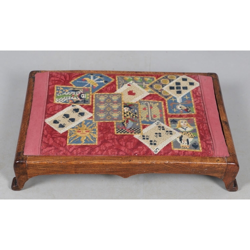 468 - A VICTORIAN OAK AND WOOLWORK FOOTSTOOL. the drop-in woolwork seat with unusual pack of cards design ... 