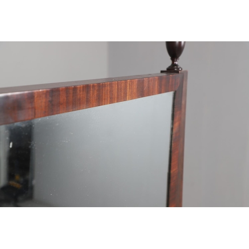 476 - A REGENCY MAHOGANY CHEVAL DRESSING MIRROR. the shorter than average frame with urn finials, on reede... 