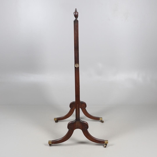 476 - A REGENCY MAHOGANY CHEVAL DRESSING MIRROR. the shorter than average frame with urn finials, on reede... 