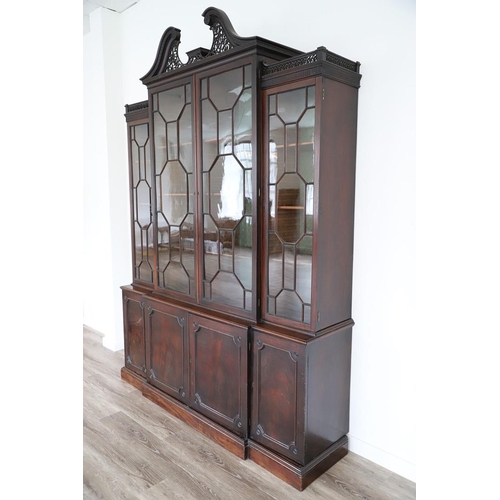 481 - A GEORGE III MAHOGANY LIBRARY BREAKFRONT BOOKCASE, CIRCA 1780. with Chippendale style fret cut scrol... 