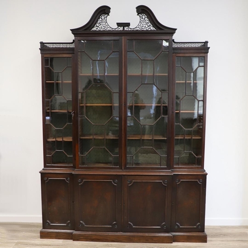 481 - A GEORGE III MAHOGANY LIBRARY BREAKFRONT BOOKCASE, CIRCA 1780. with Chippendale style fret cut scrol... 