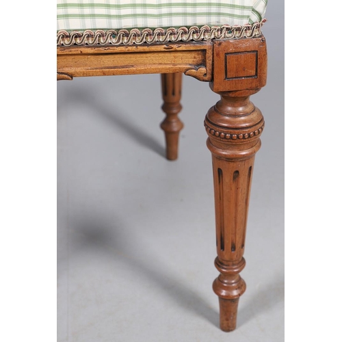 484 - A LATE 19TH CENTURY BEECH STOOL. the square top upholstered with green and cream check fabric upon t... 