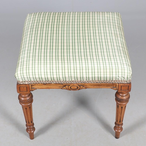 484 - A LATE 19TH CENTURY BEECH STOOL. the square top upholstered with green and cream check fabric upon t... 