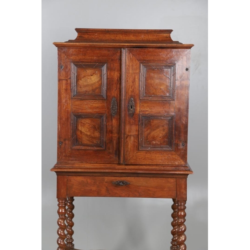 486 - AN 18TH CENTURY NORTHERN EUROPEAN OLIVEWOOD CABINET ON LATER STAND. surmounted by a drawer pediment ... 