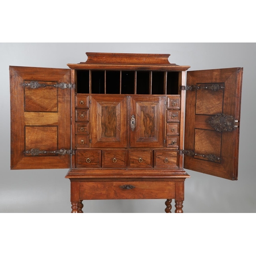 486 - AN 18TH CENTURY NORTHERN EUROPEAN OLIVEWOOD CABINET ON LATER STAND. surmounted by a drawer pediment ... 