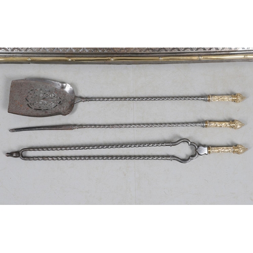 487 - A LATE 19TH CENTURY STEEL AND BRASS FIRE FENDER AND TOOLS. the fender having a top rail with intersp... 