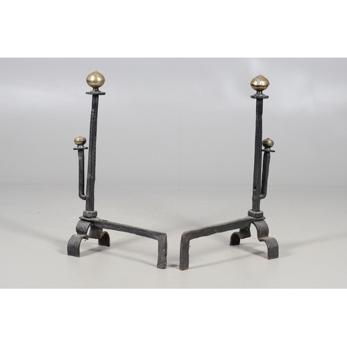 488 - A PAIR OF 18TH CENTURY STYLE WROUGHT IRON FIRE DOGS. with double brass ball finials and hammered geo... 