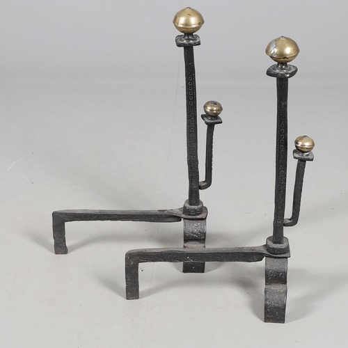 488 - A PAIR OF 18TH CENTURY STYLE WROUGHT IRON FIRE DOGS. with double brass ball finials and hammered geo... 