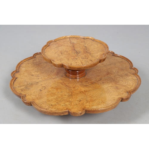 491 - AN EARLY 20TH CENTURY BURR WOOD LAZY SUSAN. with two revolving tiers to shaped oak borders and turne... 