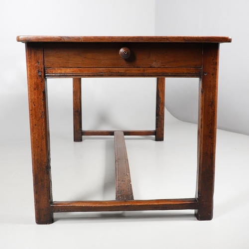 500 - A 19TH CENTURY FRUITWOOD FARMHOUSE TABLE. the multiple plank upon block supports united by a stretch... 