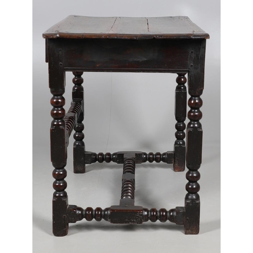 501 - A CHARLES II OAK SIDE TABLE. the moulded edge top over single drawer with applied moulding, on turne... 