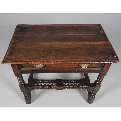 501 - A CHARLES II OAK SIDE TABLE. the moulded edge top over single drawer with applied moulding, on turne... 