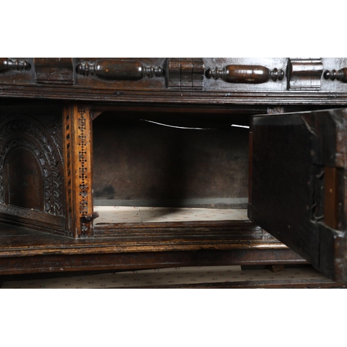 502 - A 17TH CENTURY OAK AND MARQUETRY COURT CUPBOARD. the upper trapezoidal section centred by cupboard d... 