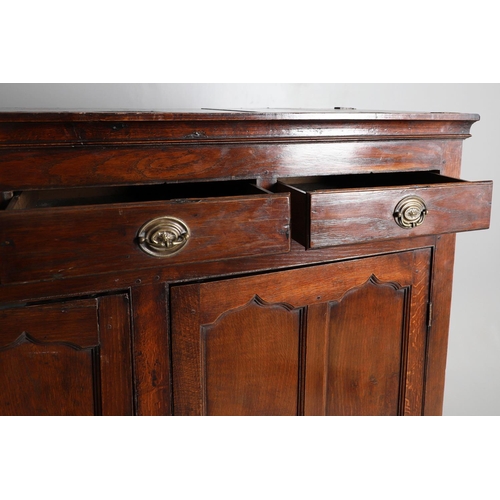 503 - AN EARLY 19TH CENTURY WELSH OAK CUPBOARD. with three small drawers above ogee arch panelled cupboard... 