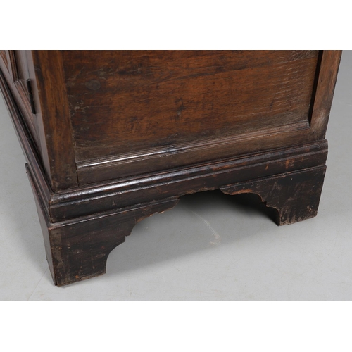 503 - AN EARLY 19TH CENTURY WELSH OAK CUPBOARD. with three small drawers above ogee arch panelled cupboard... 