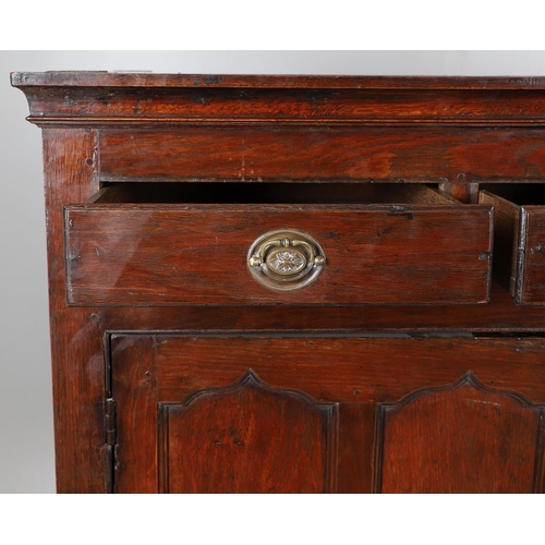 503 - AN EARLY 19TH CENTURY WELSH OAK CUPBOARD. with three small drawers above ogee arch panelled cupboard... 