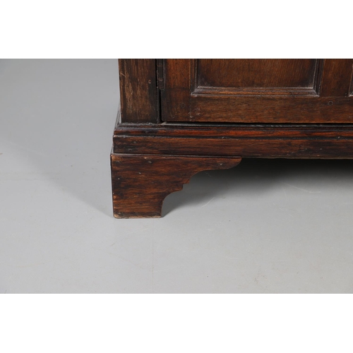 503 - AN EARLY 19TH CENTURY WELSH OAK CUPBOARD. with three small drawers above ogee arch panelled cupboard... 