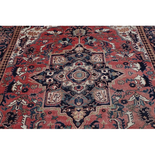 507 - A HERIZ DESIGN CARPET. the faded strawberry field centred by an indigo medallion framed by spandrels... 