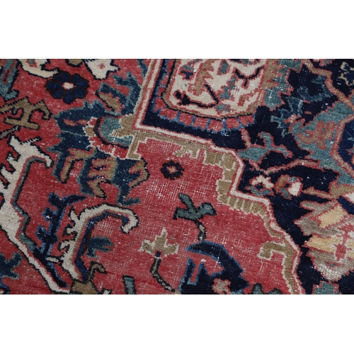 507 - A HERIZ DESIGN CARPET. the faded strawberry field centred by an indigo medallion framed by spandrels... 