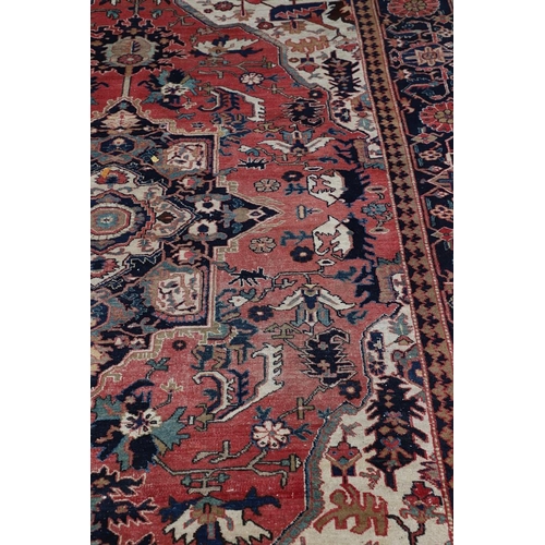 507 - A HERIZ DESIGN CARPET. the faded strawberry field centred by an indigo medallion framed by spandrels... 