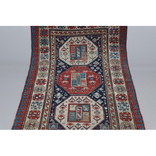 509 - A CAUCASIAN RUNNER, CIRCA 1900. the indigo field with a column of octagons containing stylised plant... 