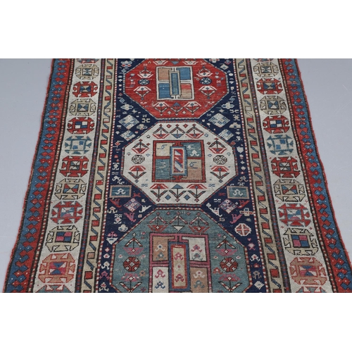 509 - A CAUCASIAN RUNNER, CIRCA 1900. the indigo field with a column of octagons containing stylised plant... 