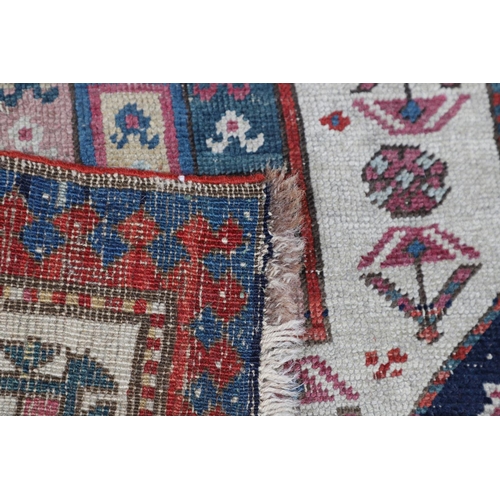 509 - A CAUCASIAN RUNNER, CIRCA 1900. the indigo field with a column of octagons containing stylised plant... 