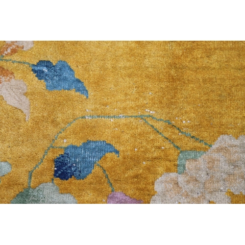 510 - A WALTER NICHOLS 'ART DECO' CHINESE CARPET, CIRCA 1925. the mustard field sparsely decorated with na... 