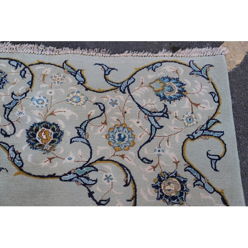 511 - A KASHAN CARPET. The pale sky blue field centred by a pole medallion surrounded by vines framed by m... 