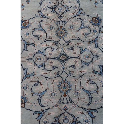 511 - A KASHAN CARPET. The pale sky blue field centred by a pole medallion surrounded by vines framed by m... 