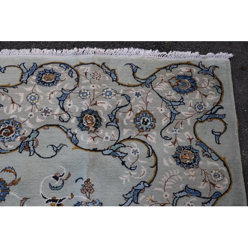 511 - A KASHAN CARPET. The pale sky blue field centred by a pole medallion surrounded by vines framed by m... 