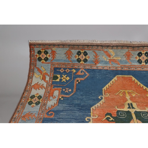 512 - A WEST ANATOLIAN CARPET, 1980S. the abrashed indigo field with central terracotta medallion framed b... 