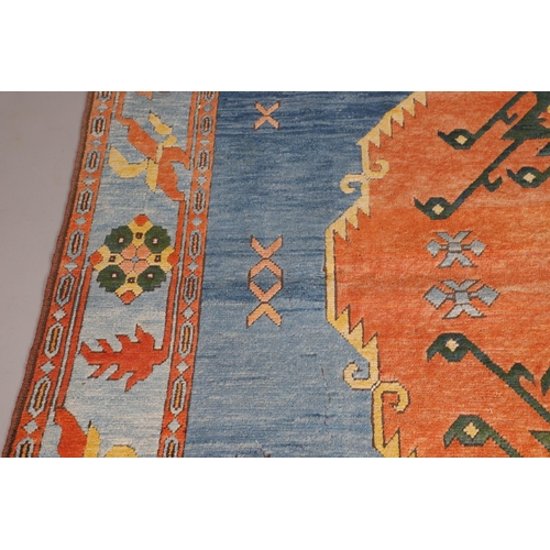 512 - A WEST ANATOLIAN CARPET, 1980S. the abrashed indigo field with central terracotta medallion framed b... 