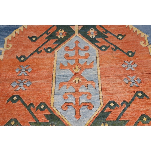 512 - A WEST ANATOLIAN CARPET, 1980S. the abrashed indigo field with central terracotta medallion framed b... 