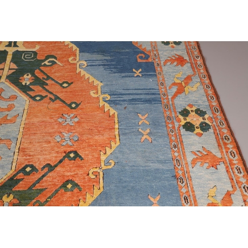 512 - A WEST ANATOLIAN CARPET, 1980S. the abrashed indigo field with central terracotta medallion framed b... 