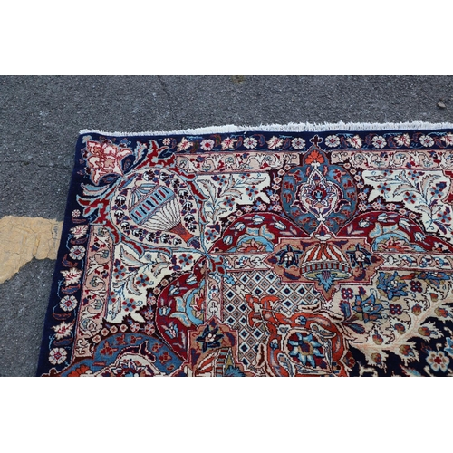 513 - A KASHMIR CARPET. the midnight blue field with vines and ears around a medallion framed by borders o... 