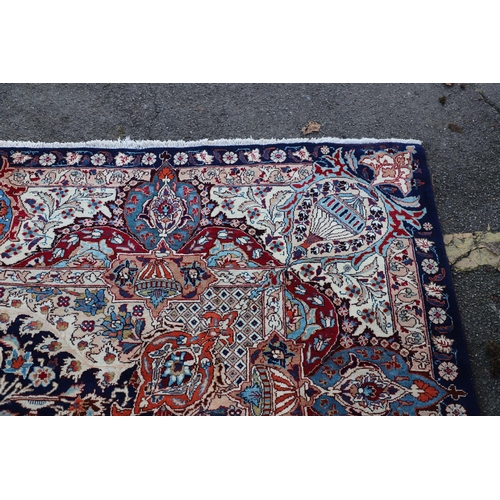 513 - A KASHMIR CARPET. the midnight blue field with vines and ears around a medallion framed by borders o... 