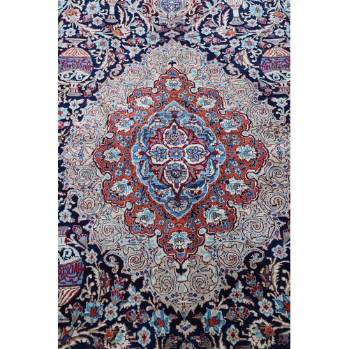 513 - A KASHMIR CARPET. the midnight blue field with vines and ears around a medallion framed by borders o... 