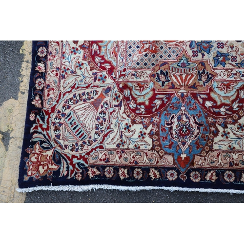 513 - A KASHMIR CARPET. the midnight blue field with vines and ears around a medallion framed by borders o... 