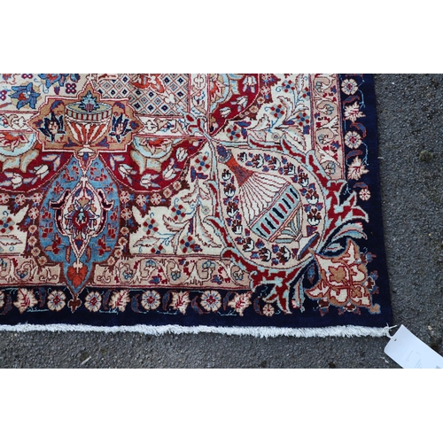 513 - A KASHMIR CARPET. the midnight blue field with vines and ears around a medallion framed by borders o... 