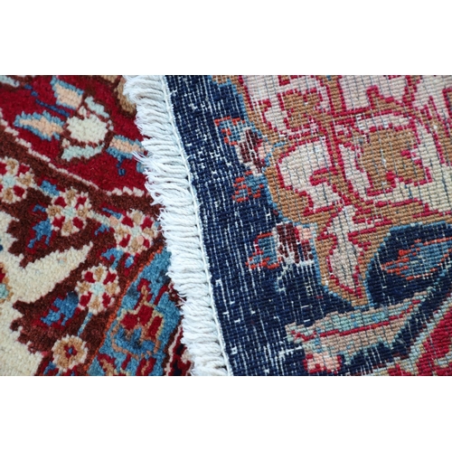 513 - A KASHMIR CARPET. the midnight blue field with vines and ears around a medallion framed by borders o... 