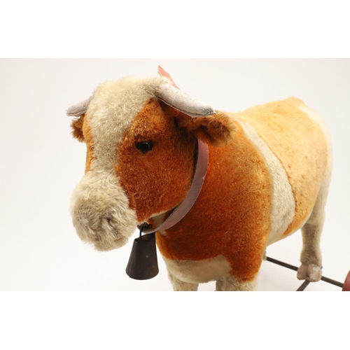 548 - UNUSUAL STEIFF PULL ALONG COW. A large early 20thc Steiff soft toy Cow, with leather horns and hoofs... 