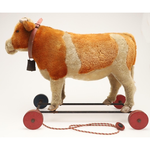 548 - UNUSUAL STEIFF PULL ALONG COW. A large early 20thc Steiff soft toy Cow, with leather horns and hoofs... 