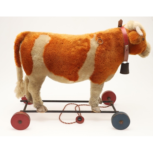 548 - UNUSUAL STEIFF PULL ALONG COW. A large early 20thc Steiff soft toy Cow, with leather horns and hoofs... 