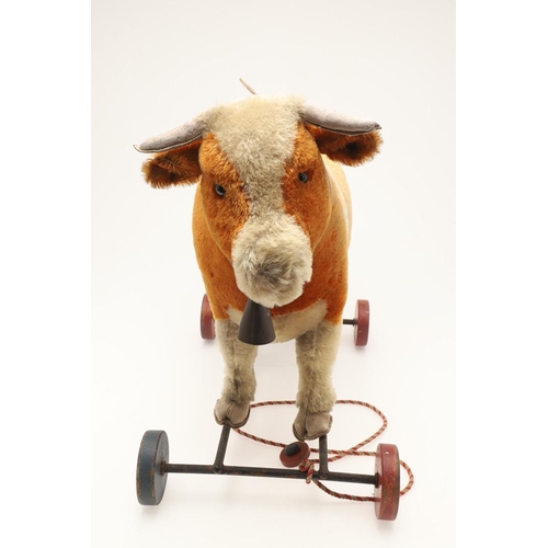 548 - UNUSUAL STEIFF PULL ALONG COW. A large early 20thc Steiff soft toy Cow, with leather horns and hoofs... 