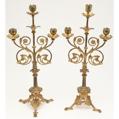 551 - PAIR OF ARTS & CRAFTS GILT BRASS CANDLESTICKS. In the manner of Eugene Emmanuel Viollet Le Duc, the ... 