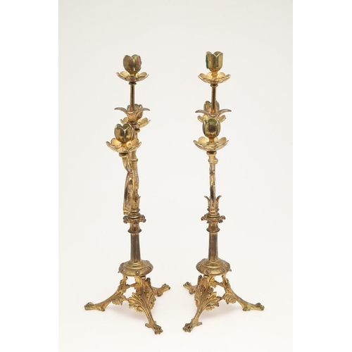 551 - PAIR OF ARTS & CRAFTS GILT BRASS CANDLESTICKS. In the manner of Eugene Emmanuel Viollet Le Duc, the ... 