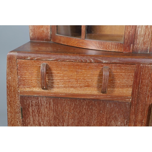 553 - ART DECO LIMED OAK SIDEBOARD - POSSIBLY BY HEALS. A limed oak sideboard possibly by Heals, the bow f... 