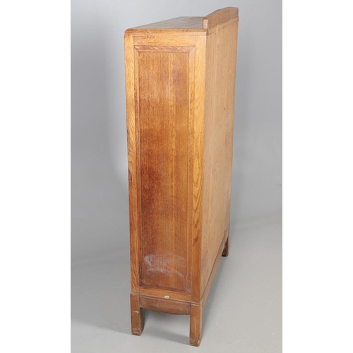 556 - BRYNMAWR FURNITURE - OAK DISPLAY CABINET. An oak display cabinet with a glazed top section with a si... 