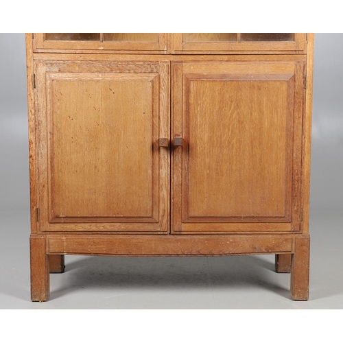 556 - BRYNMAWR FURNITURE - OAK DISPLAY CABINET. An oak display cabinet with a glazed top section with a si... 